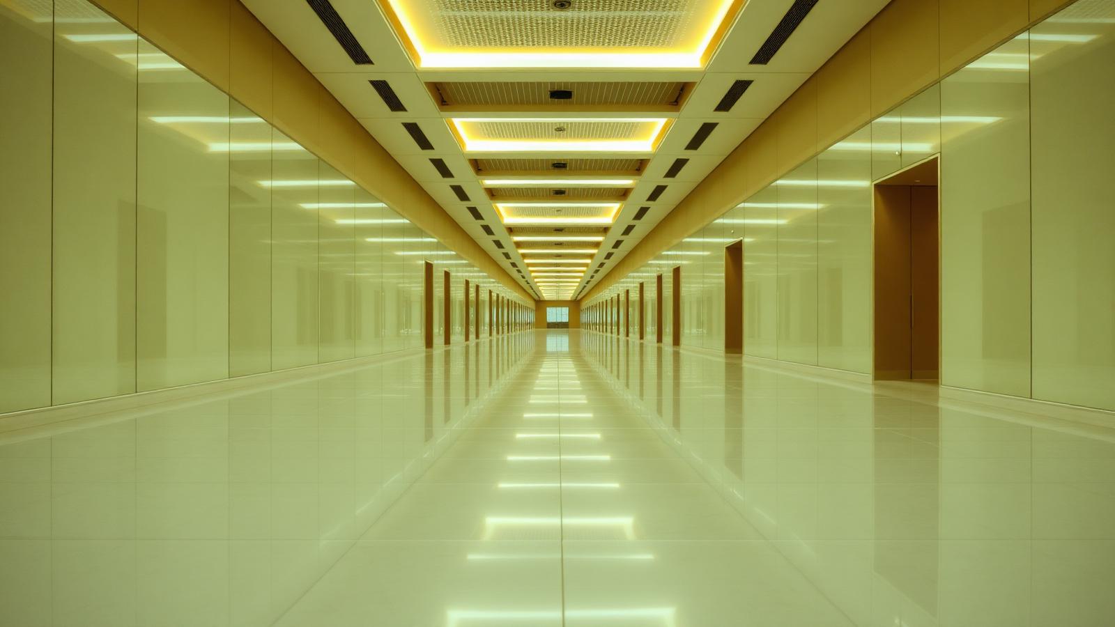 A polished commercial corridor reflecting overhead lighting